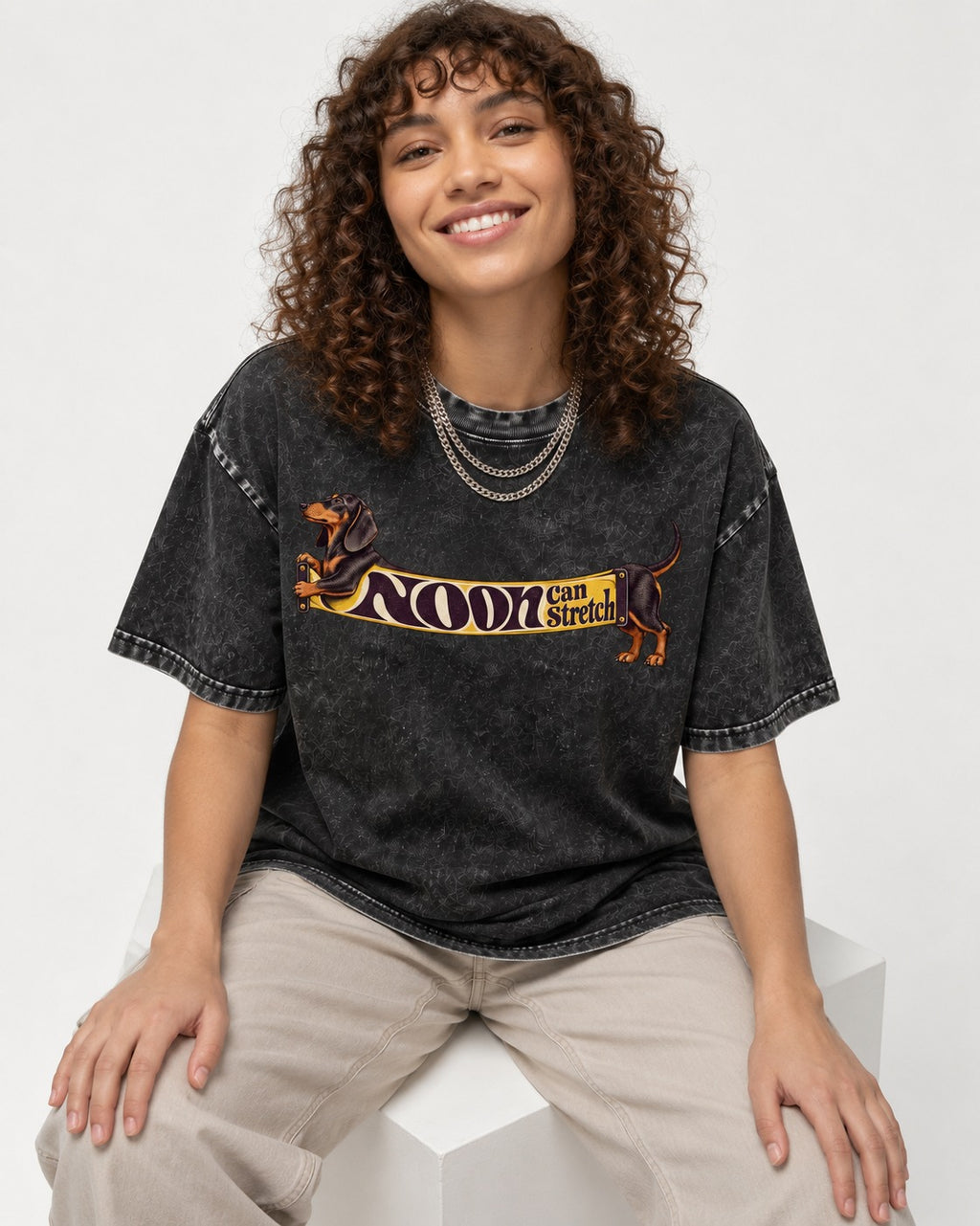 Dachshund Noon Can Stretch Sign Graphic Washed Tee in Black, worn by a seated model