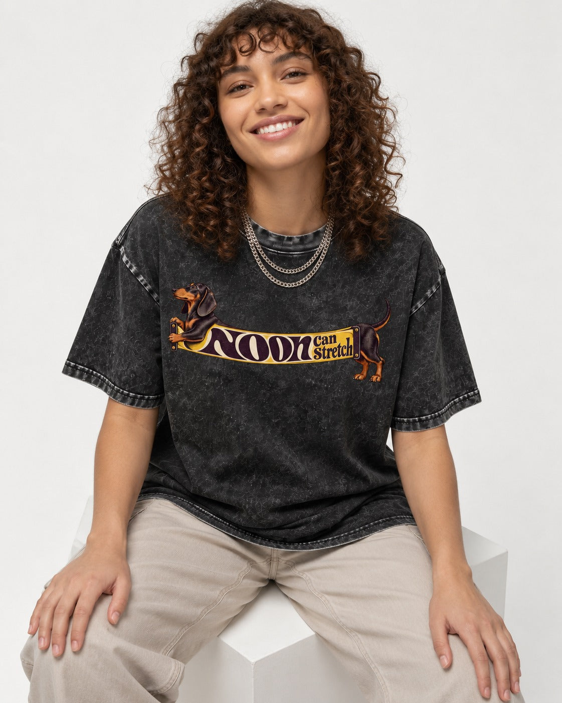 Dachshund Noon Can Stretch Sign Graphic Washed Tee in Black, worn by a seated model