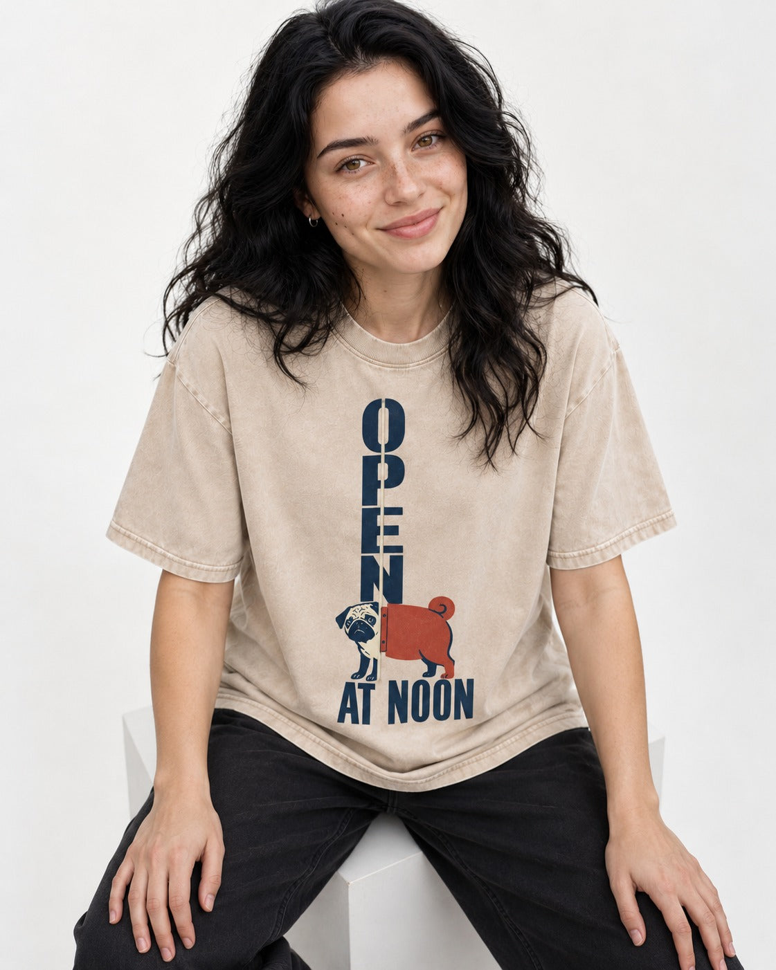 Pug Open at Noon Washed Tee in Apricot, worn by a seated model