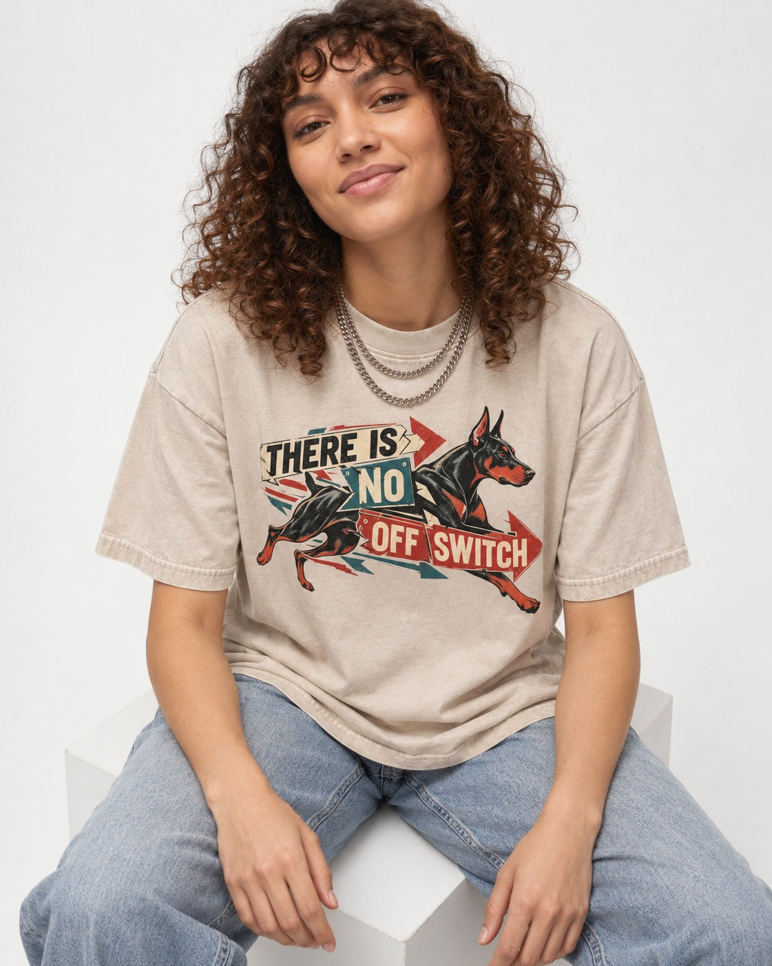 Doberman There Is No Off Switch Arrow Sprint Graphic Washed Tee in Apricot, worn by a seated model