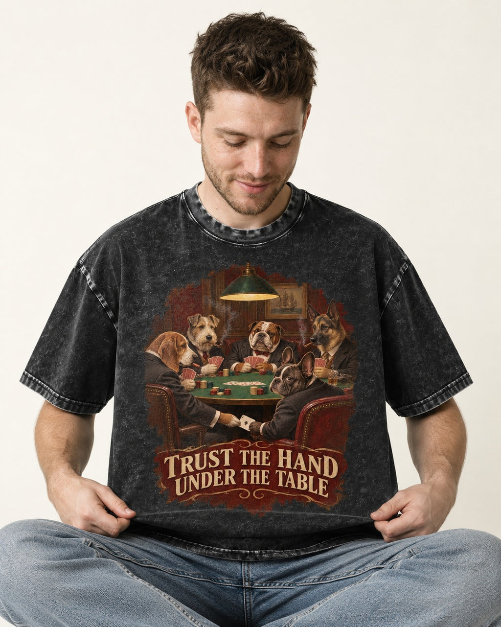 Frenchie Trust the Hand Under the Table Poker Dogs Graphic Washed Tee in Black, worn by a seated model