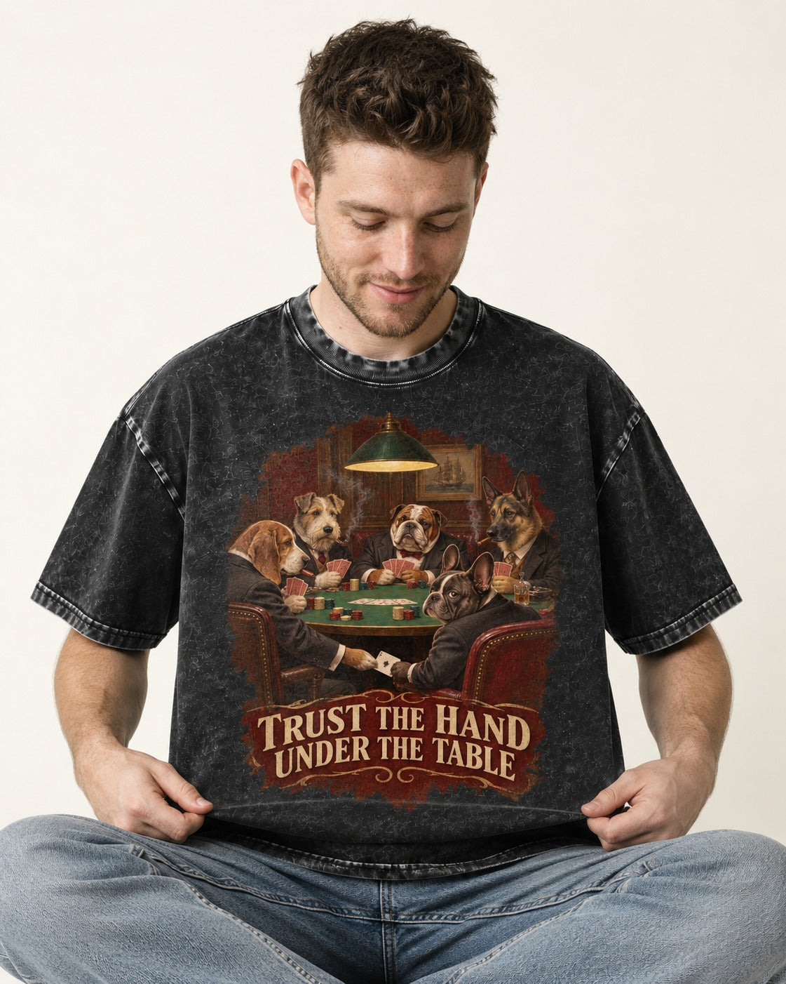 Frenchie Trust the Hand Under the Table Poker Dogs Graphic Washed Tee in Black, worn by a seated model