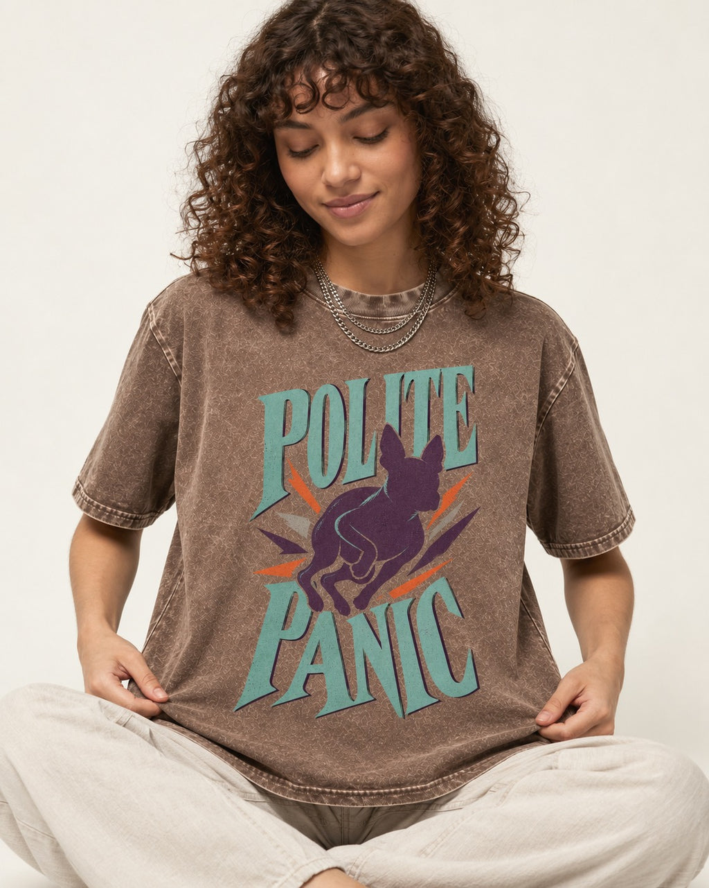 Polite Panic Boston Terrier Washed Tee in Coffee, worn by a seated model