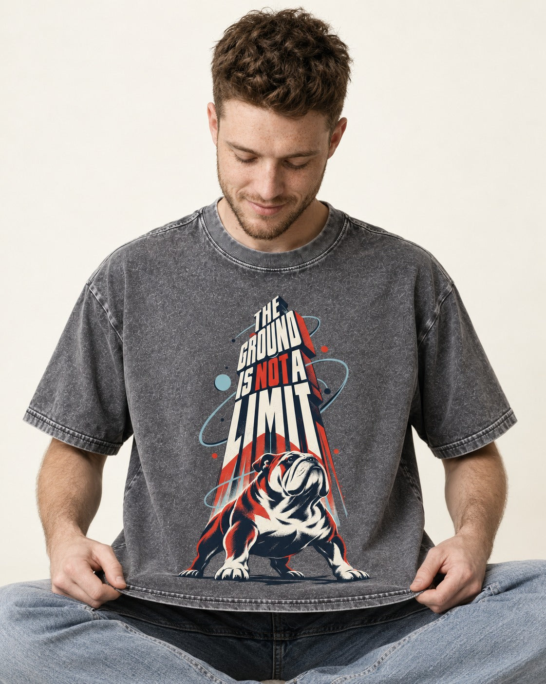 English Bulldog The Ground Is Not a Limit Orbital Graphic Washed Tee in Gray, worn by a seated model