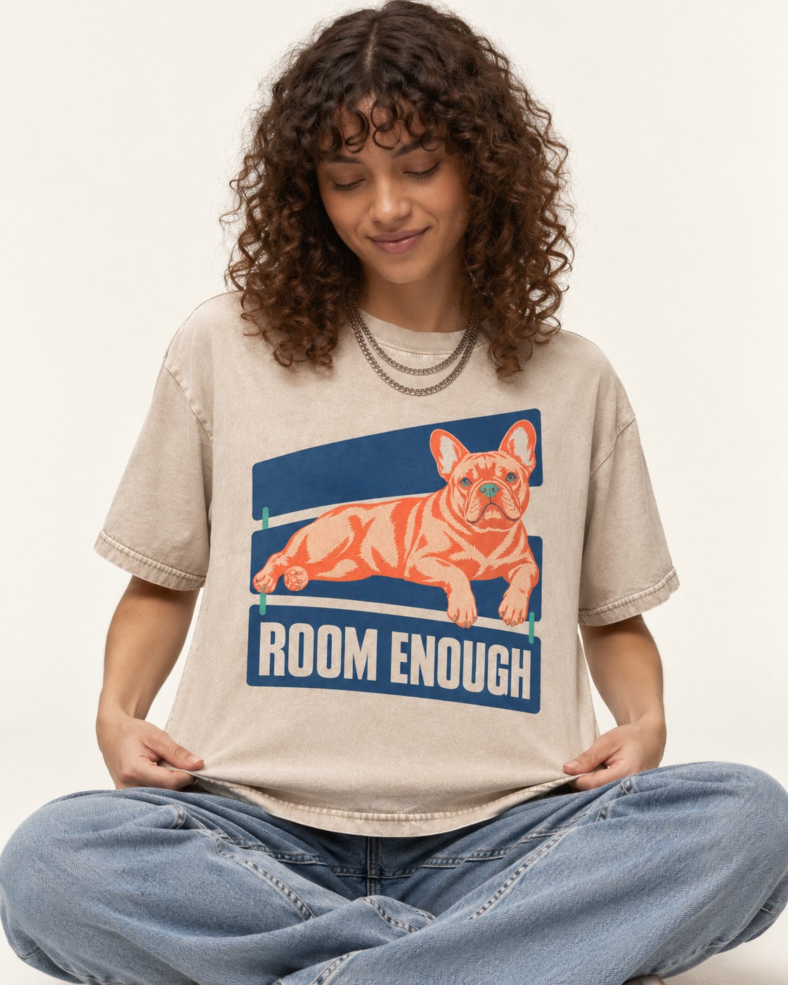 Room Enough for Frenchie Washed Tee in Apricot, worn by a seated model