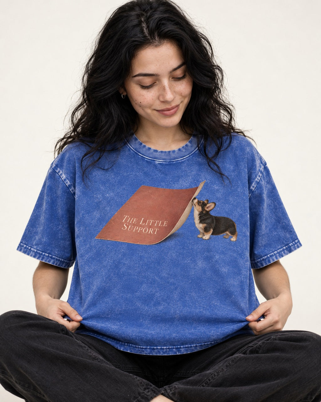 Corgi The Little Support Paper Graphic Washed Tee in Royal Blue, worn by a seated model
