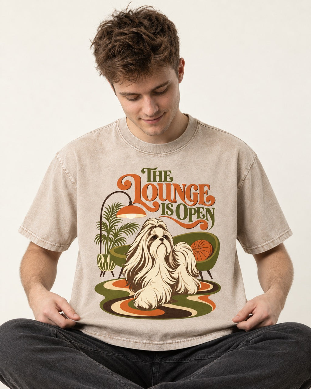 The Shih Tzu Lounge Is Open Washed Tee in Apricot, worn by a seated model
