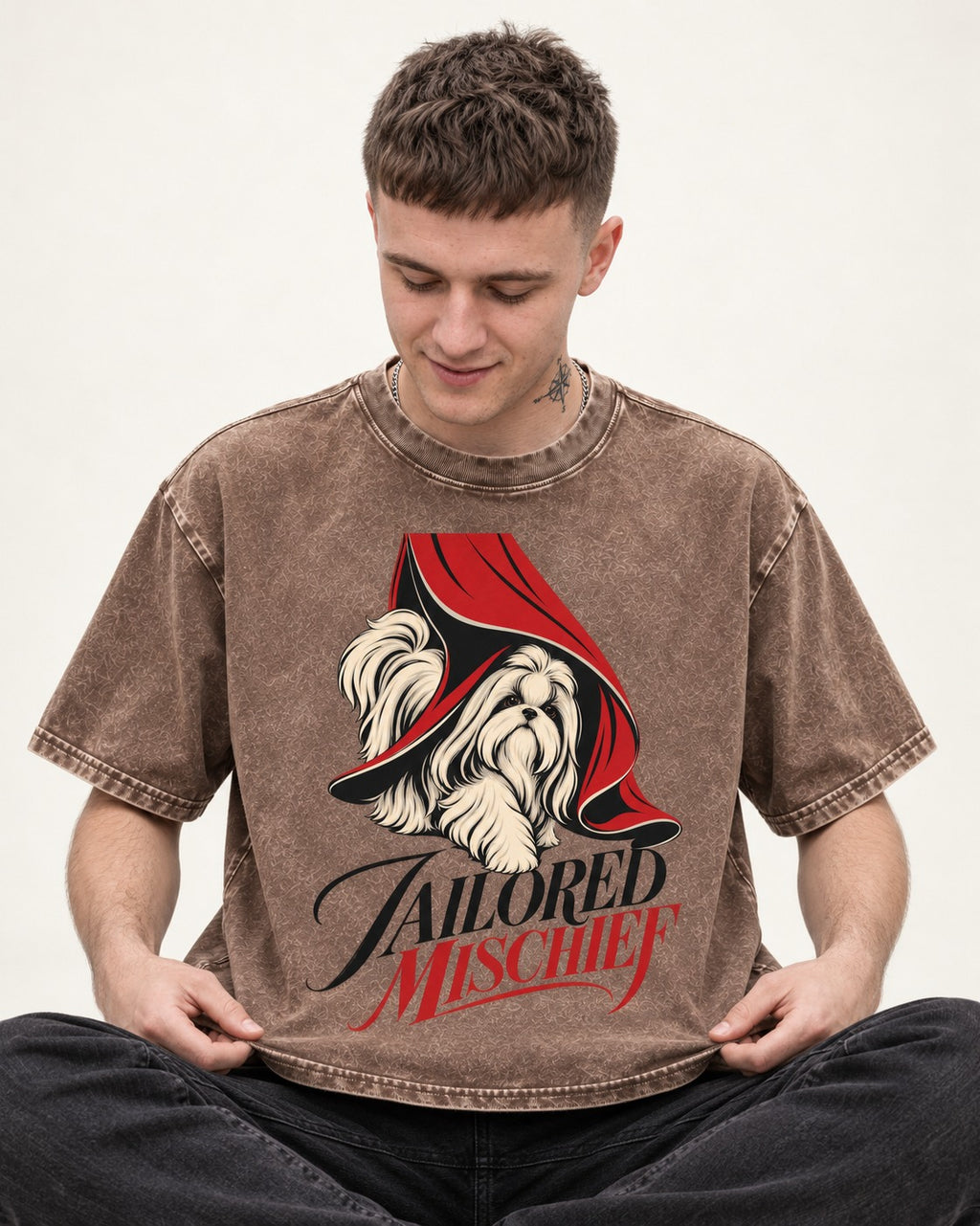 Tailored Mischief Shih Tzu Washed Tee in Coffee, worn by a seated model