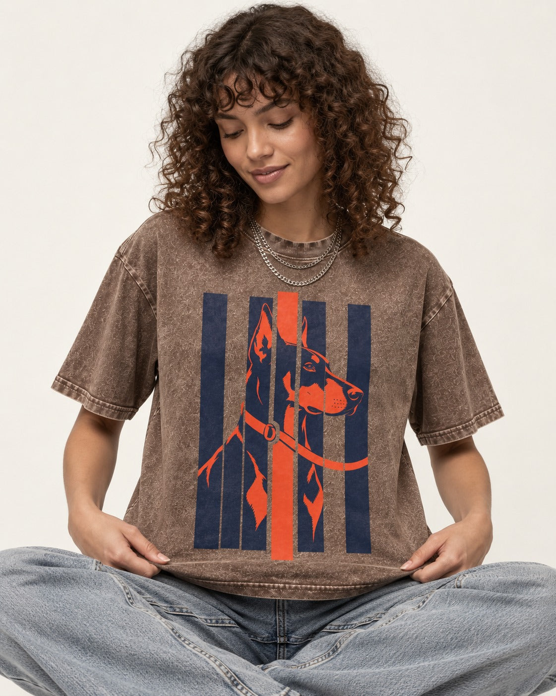Doberman Orange Navy Vertical Slat Portrait Graphic Washed Tee in Coffee, worn by a seated model