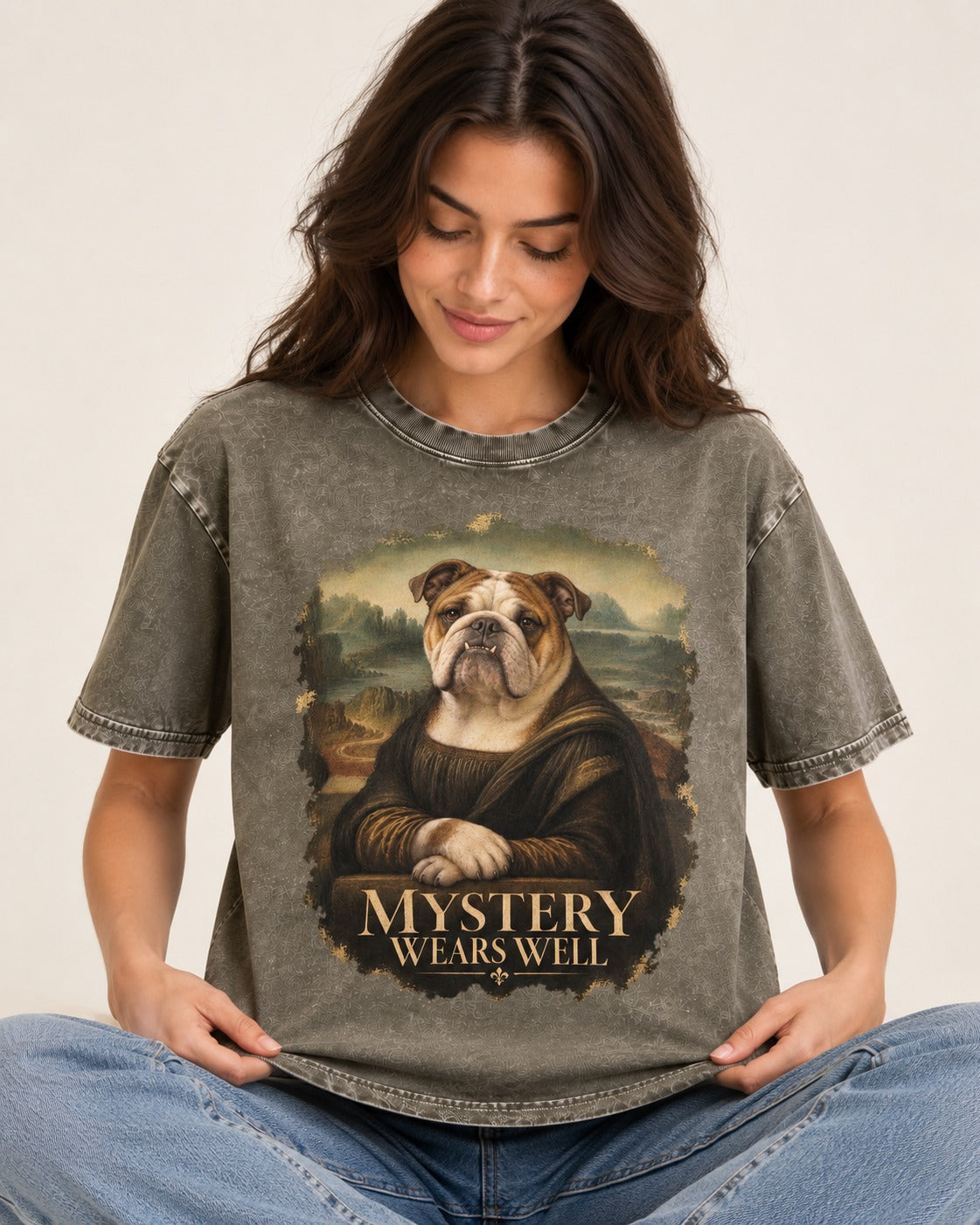 English Bulldog Mystery Wears Well Mona Lisa Portrait Washed Tee in Army Green, worn by a seated model