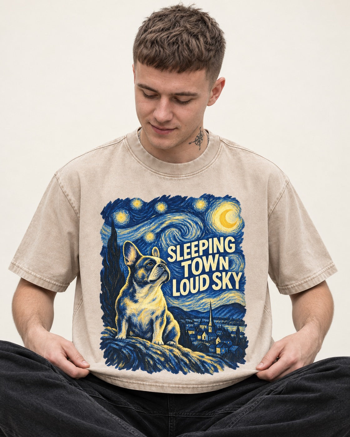 Frenchie Sleeping Town Loud Sky Graphic Washed Tee in Apricot, worn by a seated model