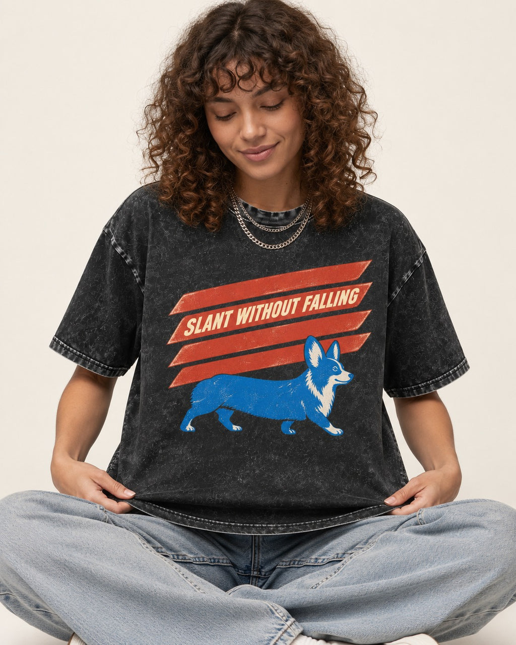 Corgi Slant Without Falling Speed Graphic Washed Tee in Black, worn by a seated model