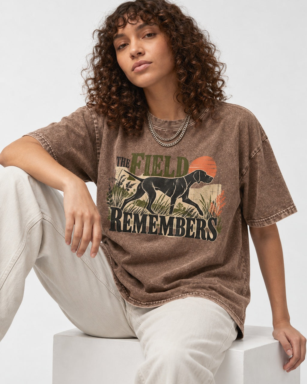 The Field Remembers German Shorthaired Pointer Washed Tee in Coffee, worn by a seated model