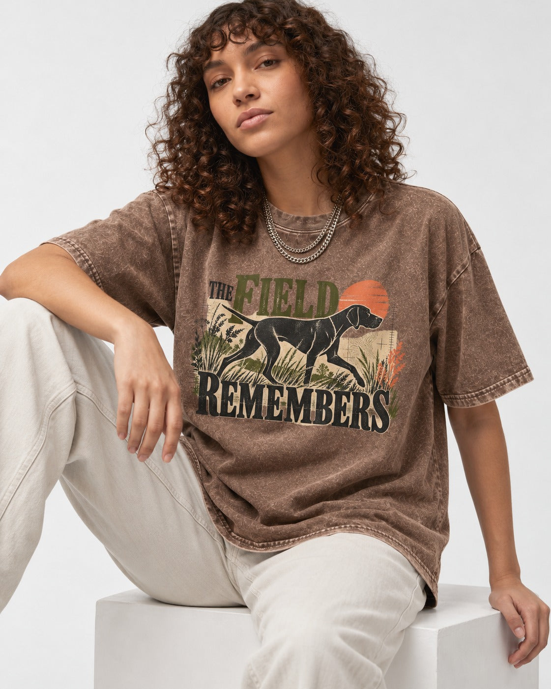 The Field Remembers German Shorthaired Pointer Washed Tee in Coffee, worn by a seated model