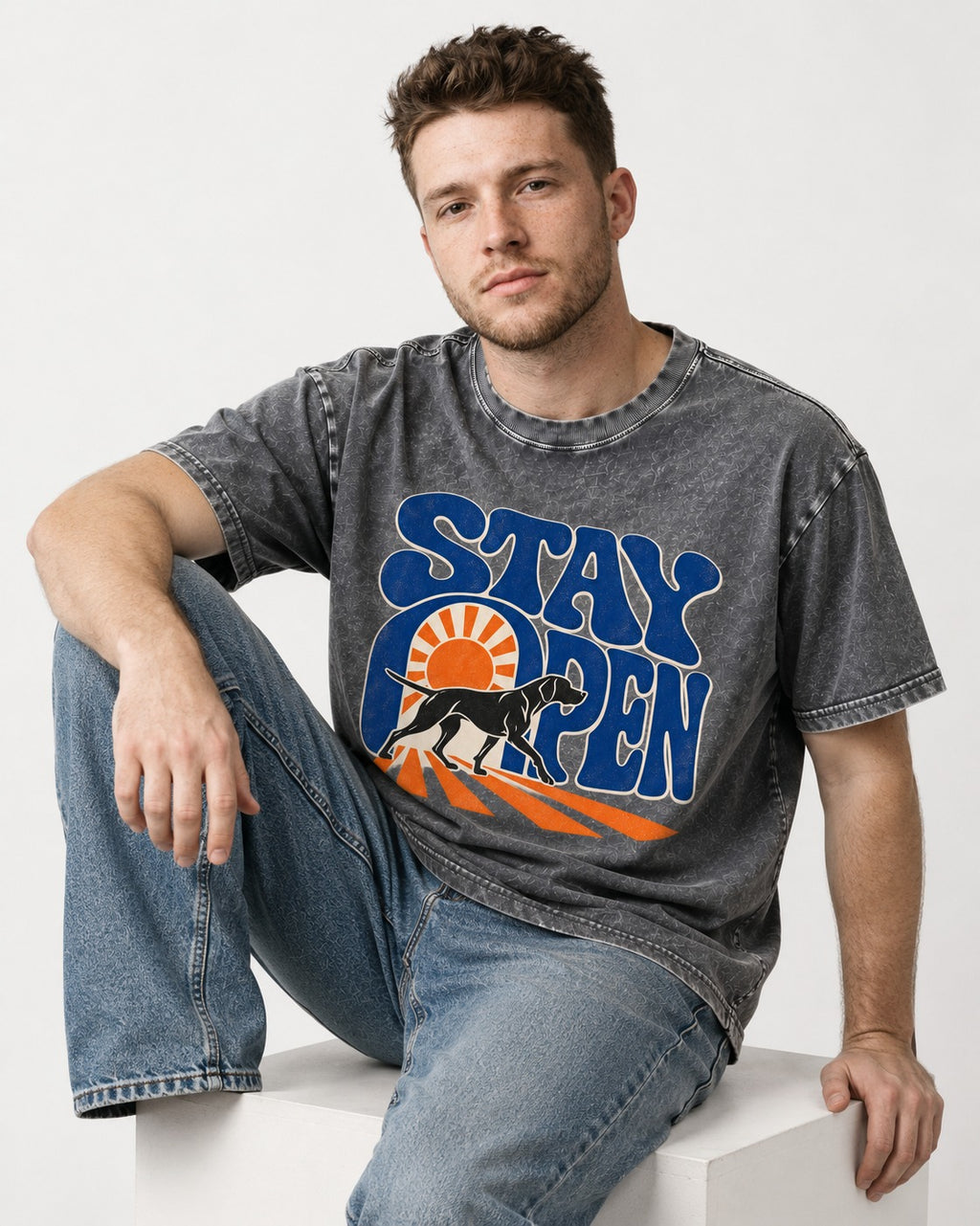 Stay Open German Shorthaired Pointer Washed Tee in Gray, worn by a seated model