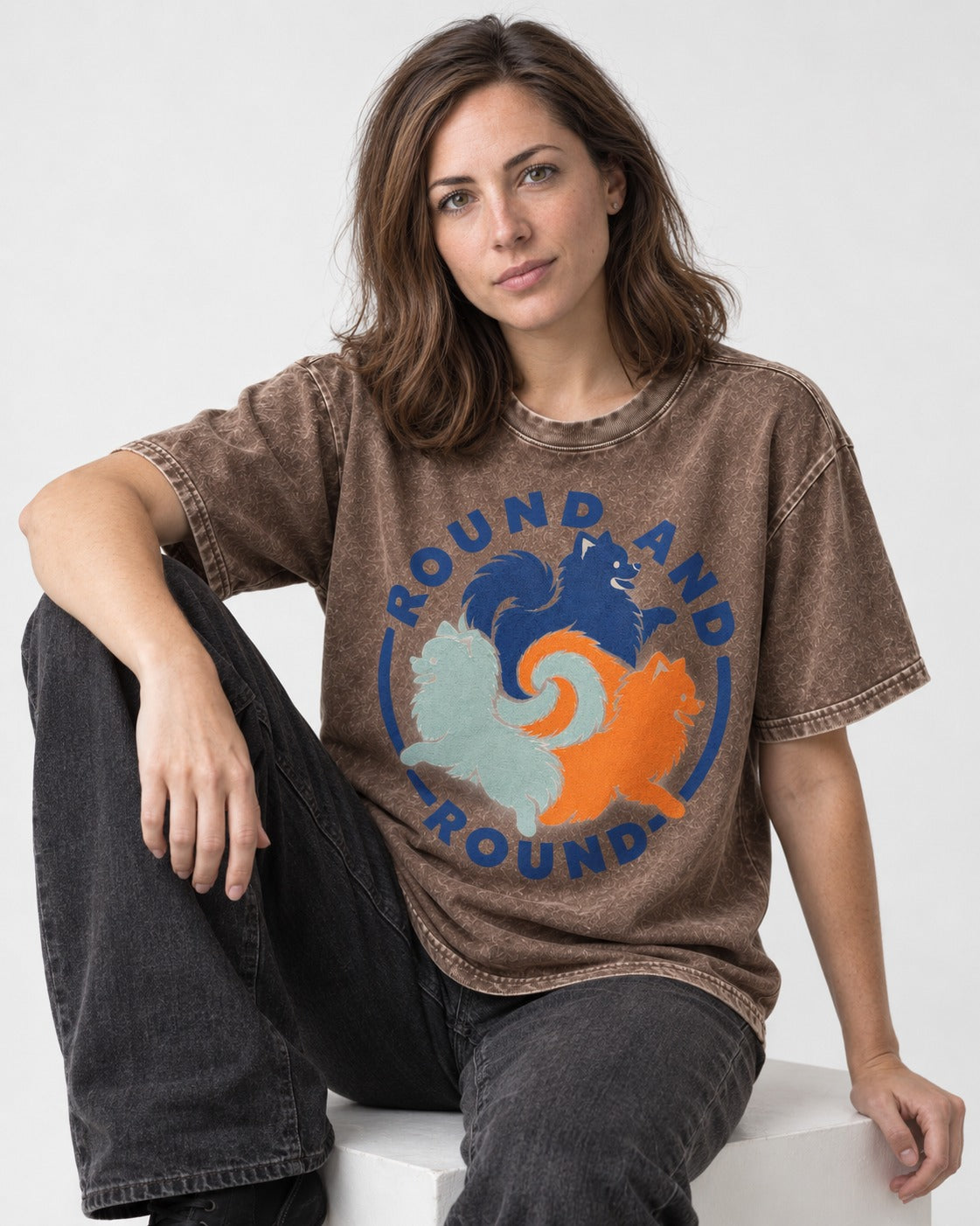 Pomeranian Round and Round Washed Tee in Coffee, worn by a seated model
