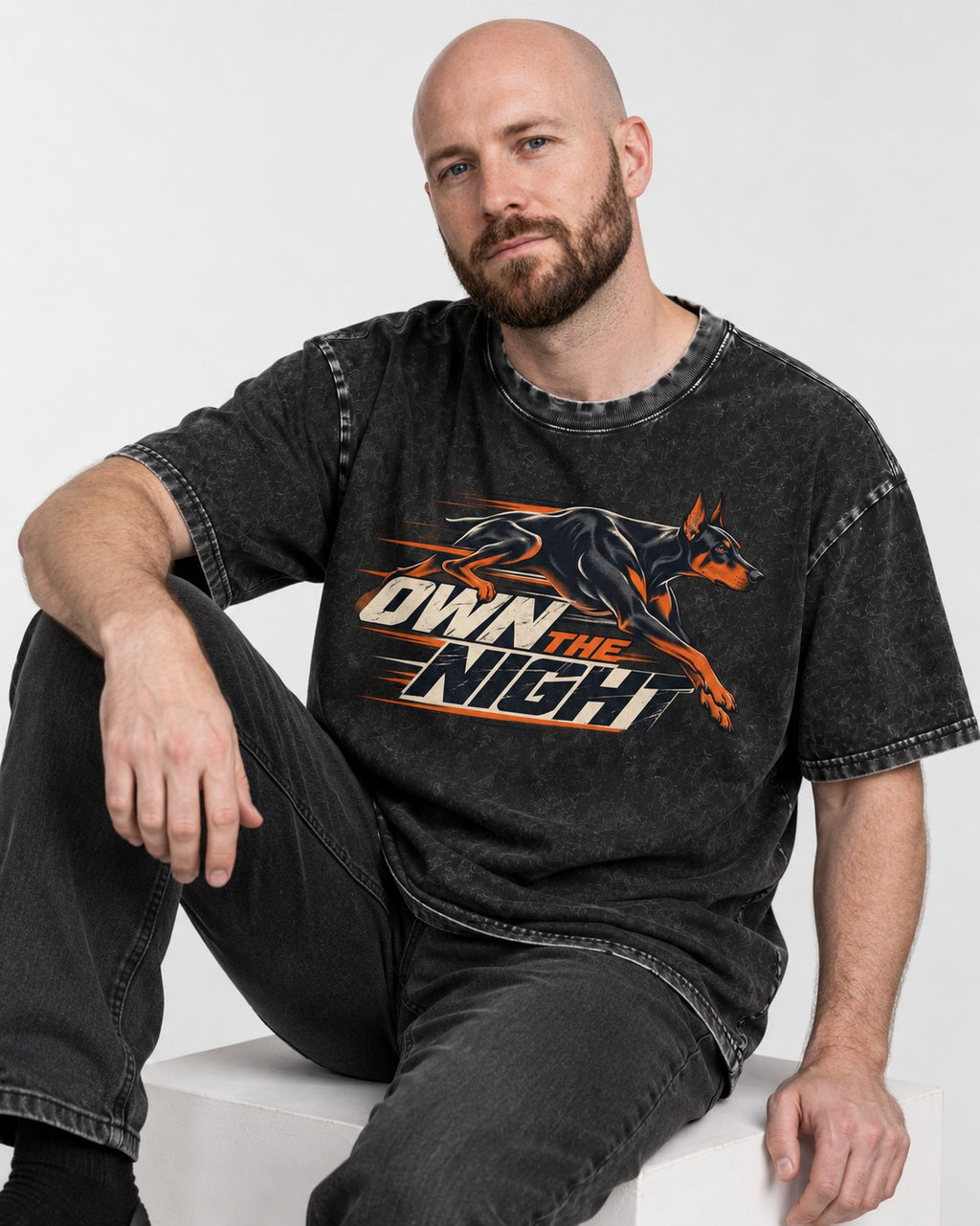 Doberman Own the Night Speed Graphic Washed Tee in Black, worn by a seated model
