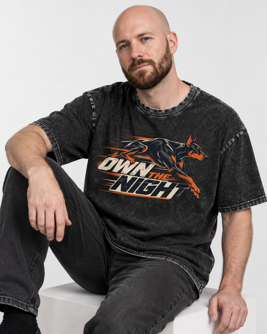 Doberman Own the Night Speed Graphic Washed Tee in Black, worn by a seated model