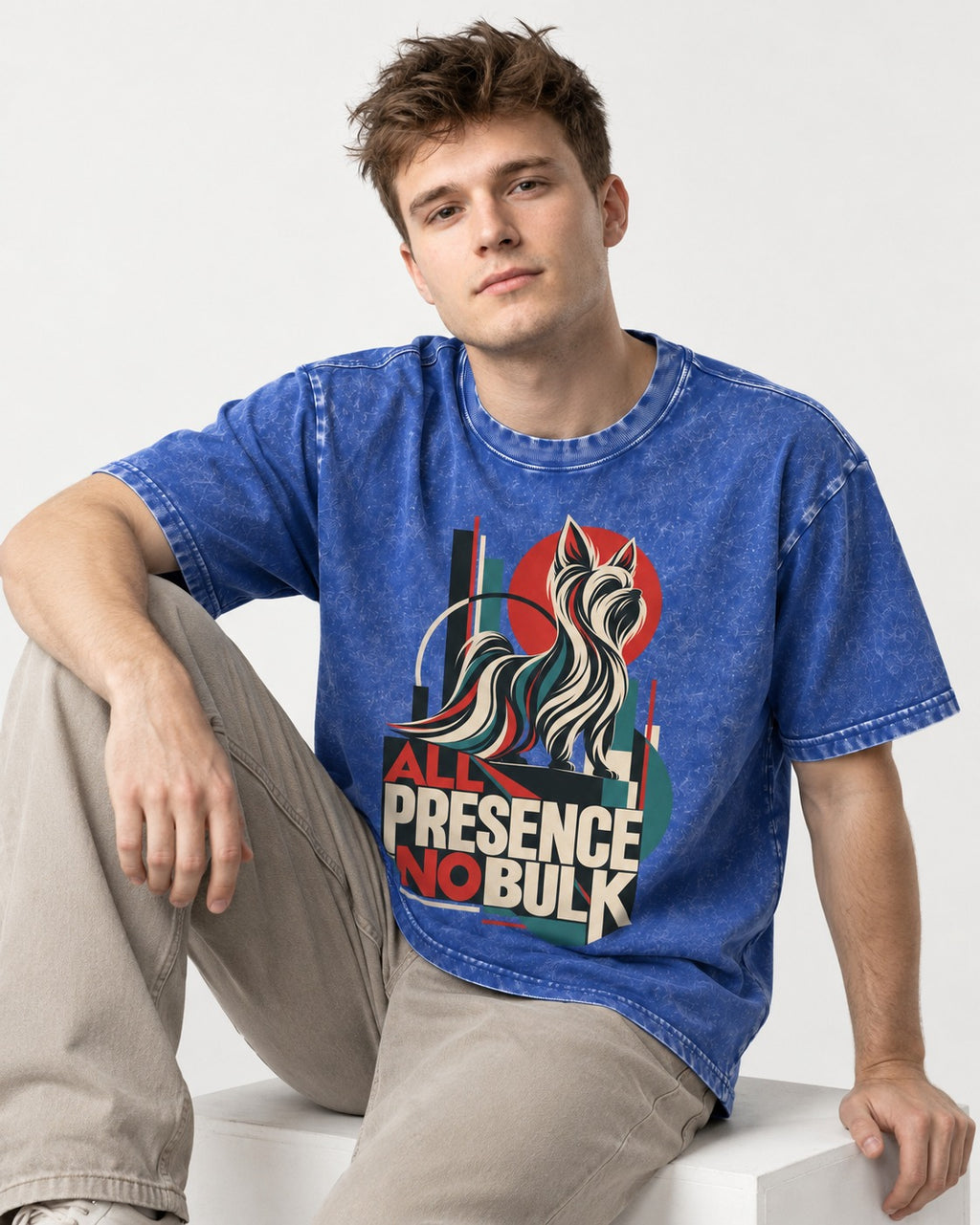 Yorkshire Terrier All Presence No Bulk Geometric Portrait Graphic Washed Tee in Royal Blue, worn by a seated model
