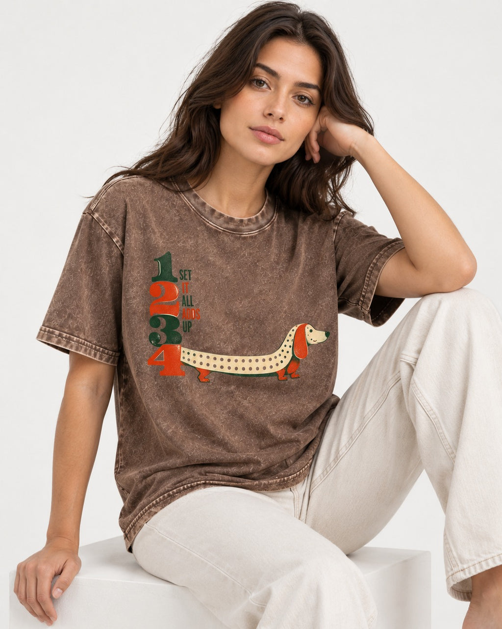 Dachshund Adds Up Washed Tee in Coffee, worn by a seated model