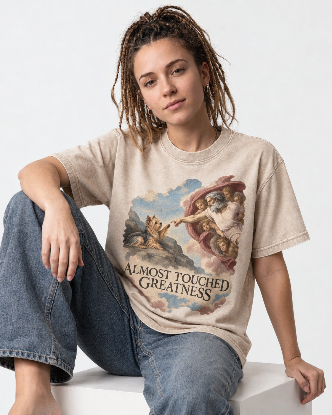 Yorkshire Terrier Almost Touched Greatness Creation Parody Graphic Washed Tee in Apricot, worn by a seated model