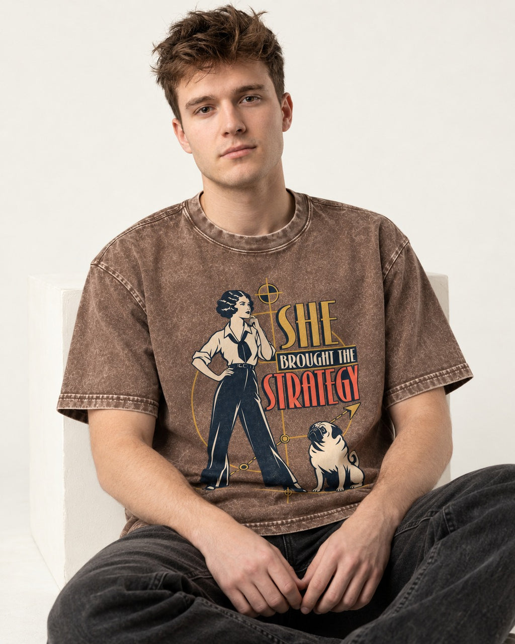 The Pug Strategy Washed Tee in Coffee, worn by a seated model