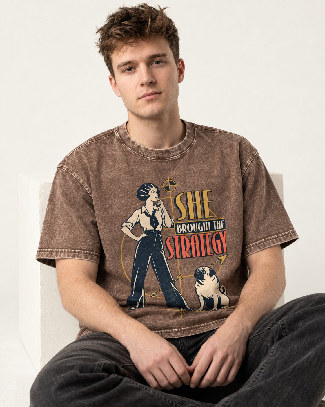 The Pug Strategy Washed Tee in Coffee, worn by a seated model