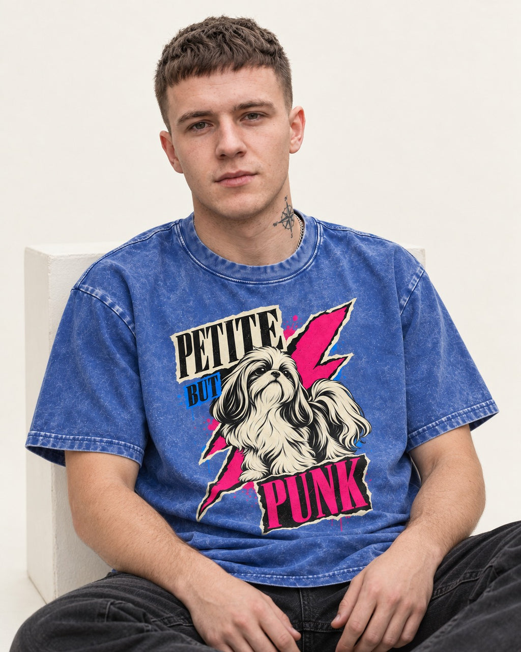 Shih Tzu Petite but Punk Lightning Graphic Washed Tee in Royal Blue, worn by a seated model