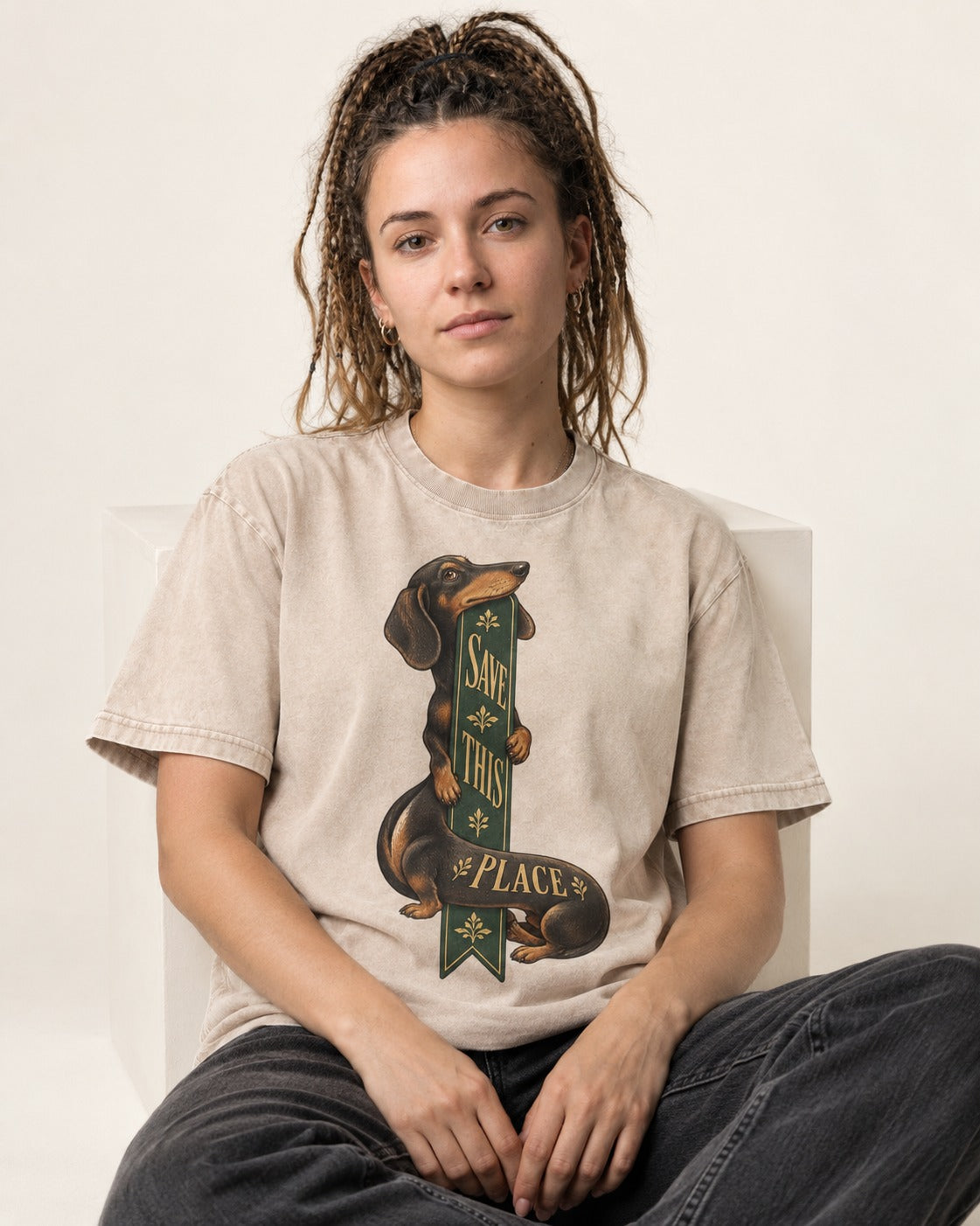 Save This Place Dachshund Washed Tee in Apricot, worn by a seated model