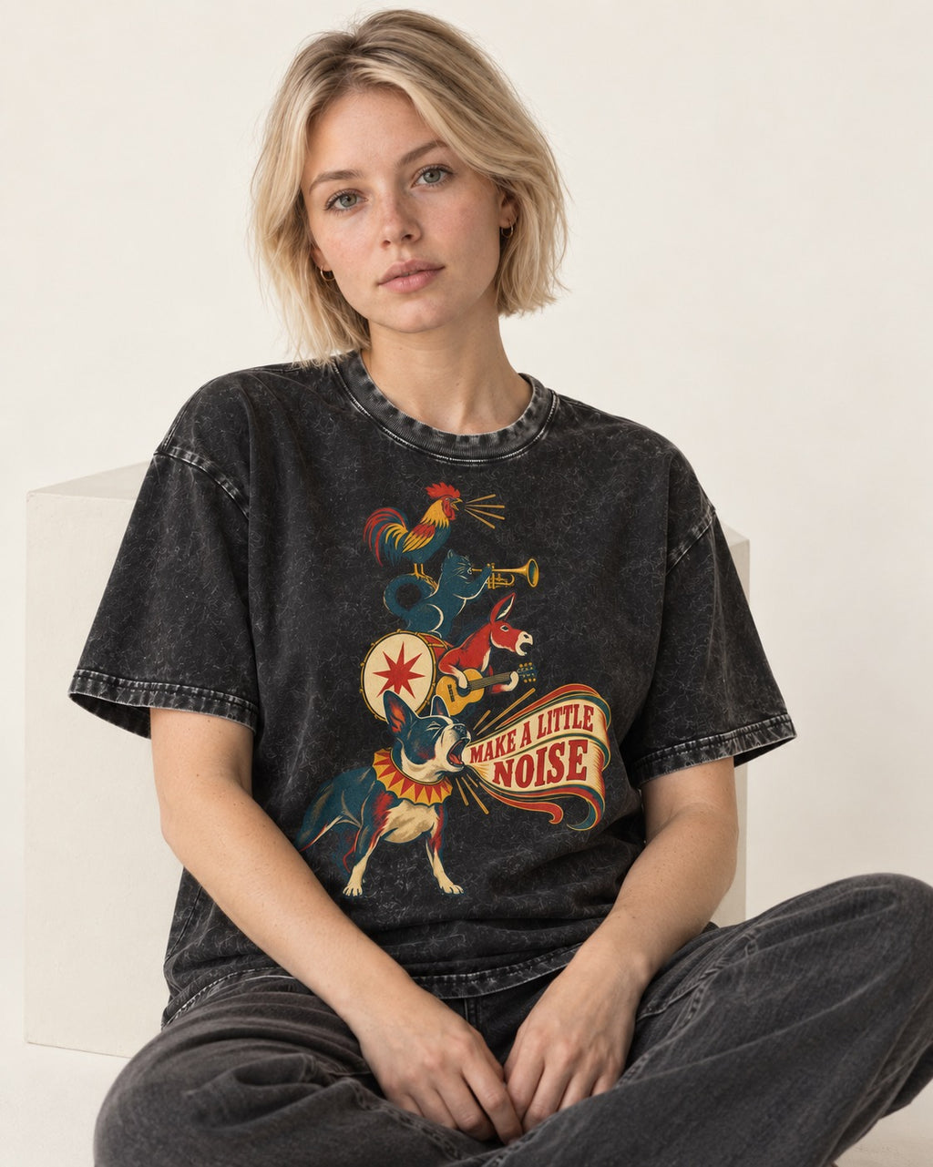 Boston Terrier Make A Little Noise Washed Tee in Black, worn by a seated model