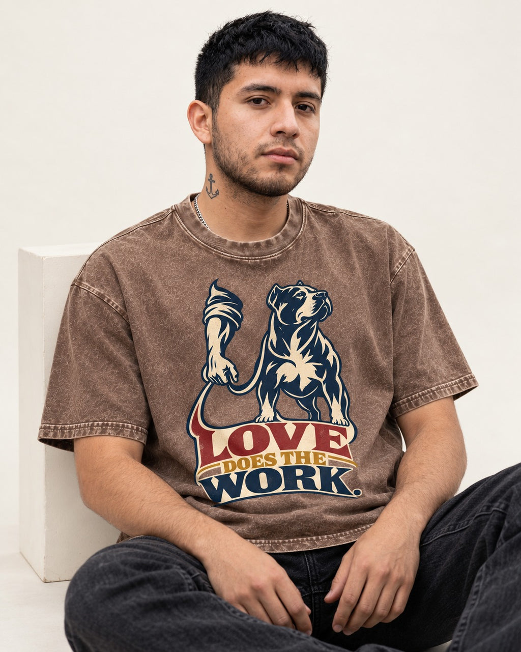 Pitbull Love Does the Work Washed Tee in Coffee, worn by a seated model