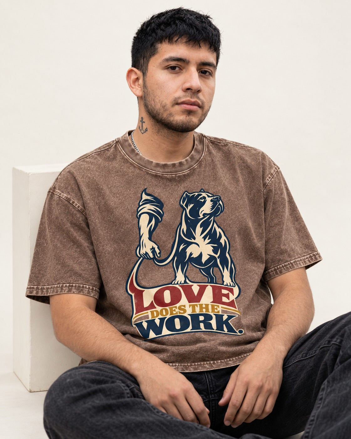 Pitbull Love Does the Work Washed Tee in Coffee, worn by a seated model