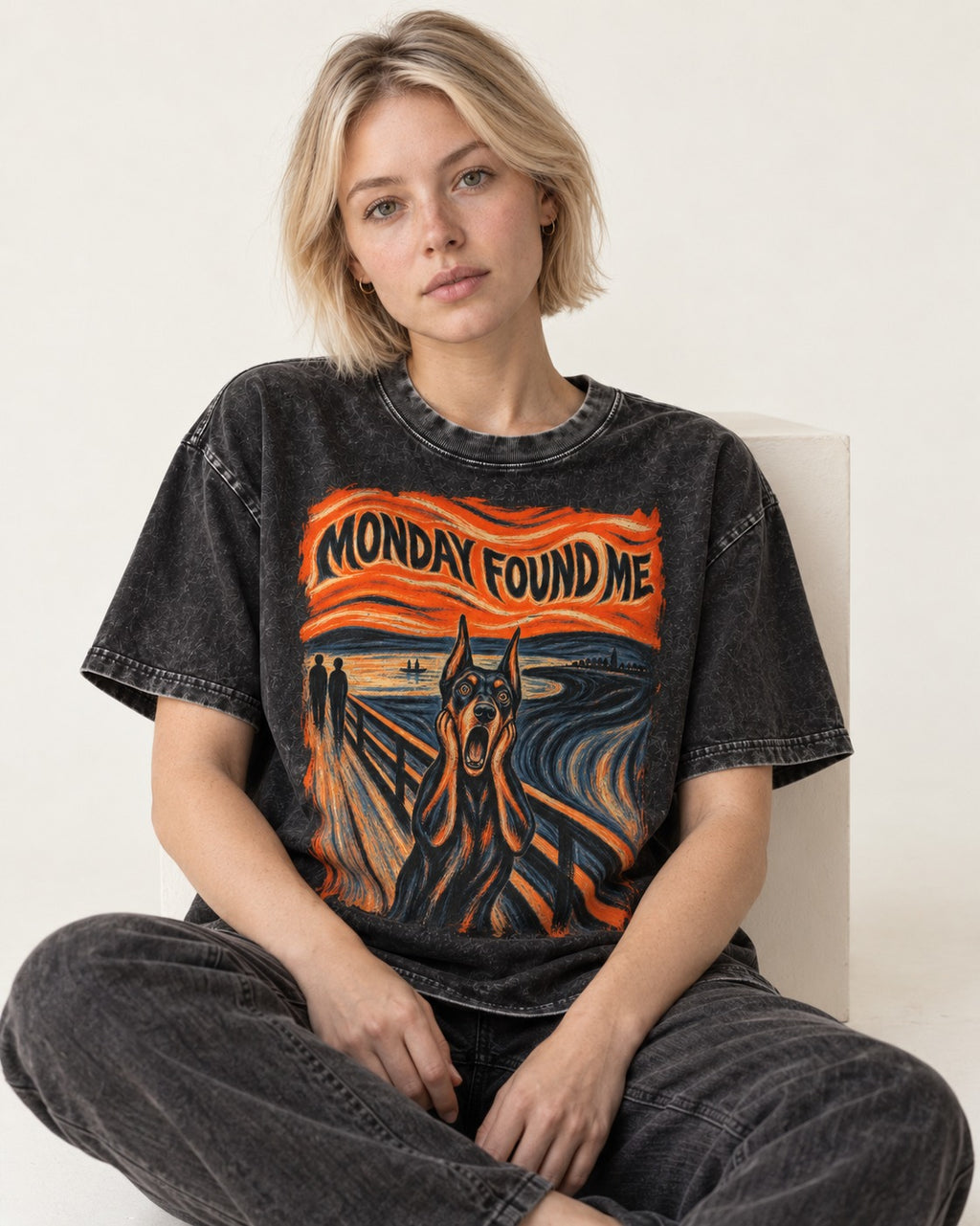 Doberman Monday Found Me Scream Graphic Washed Tee in Black, worn by a seated model