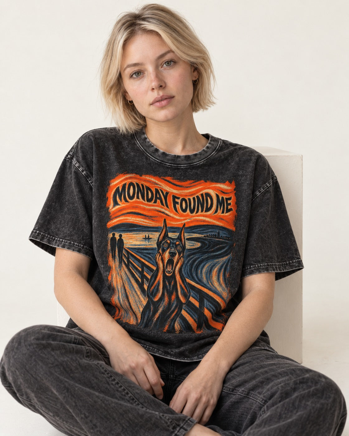 Doberman Monday Found Me Scream Graphic Washed Tee in Black, worn by a seated model