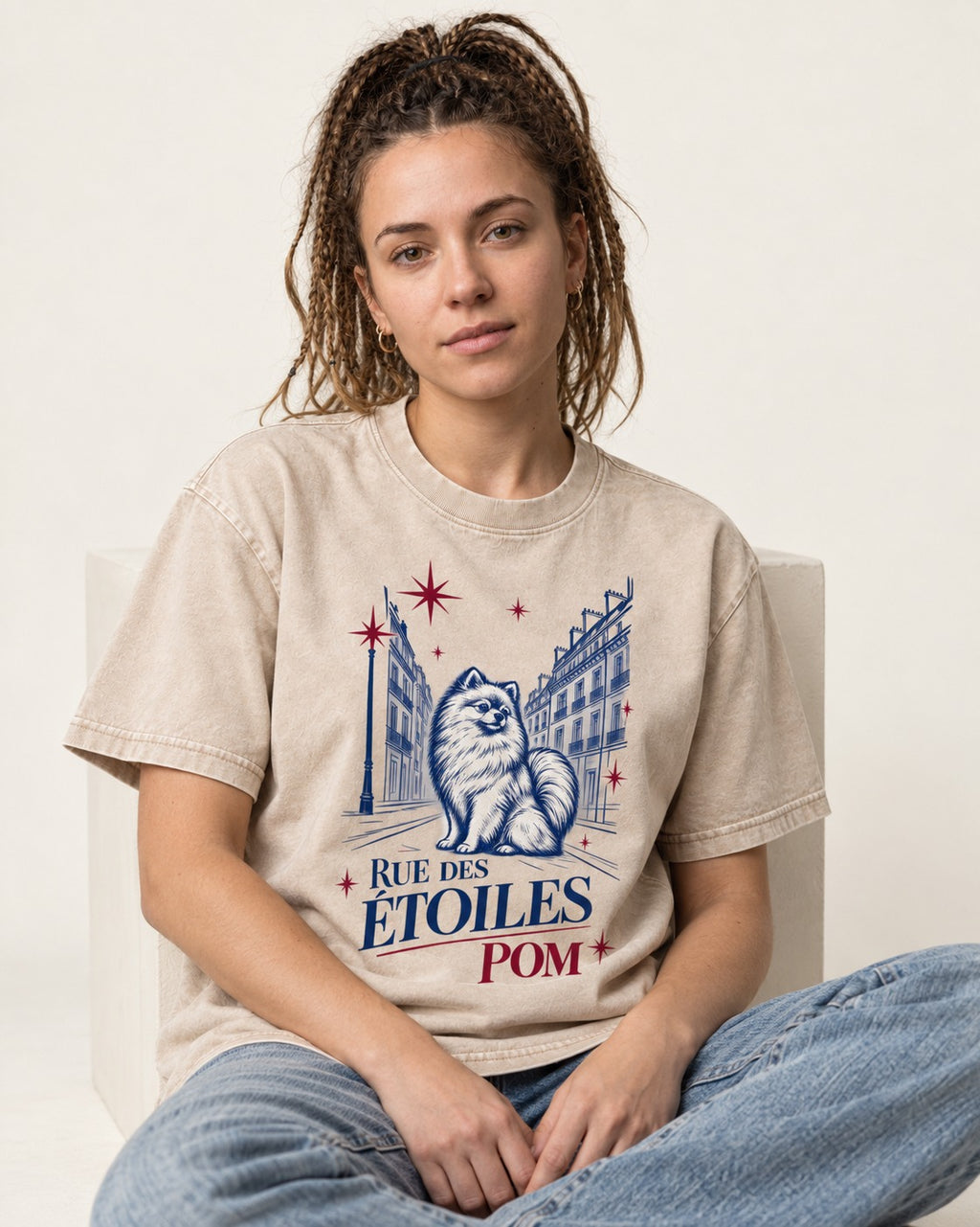 Pomeranian Among the Stars Washed Tee in Apricot, worn by a seated model