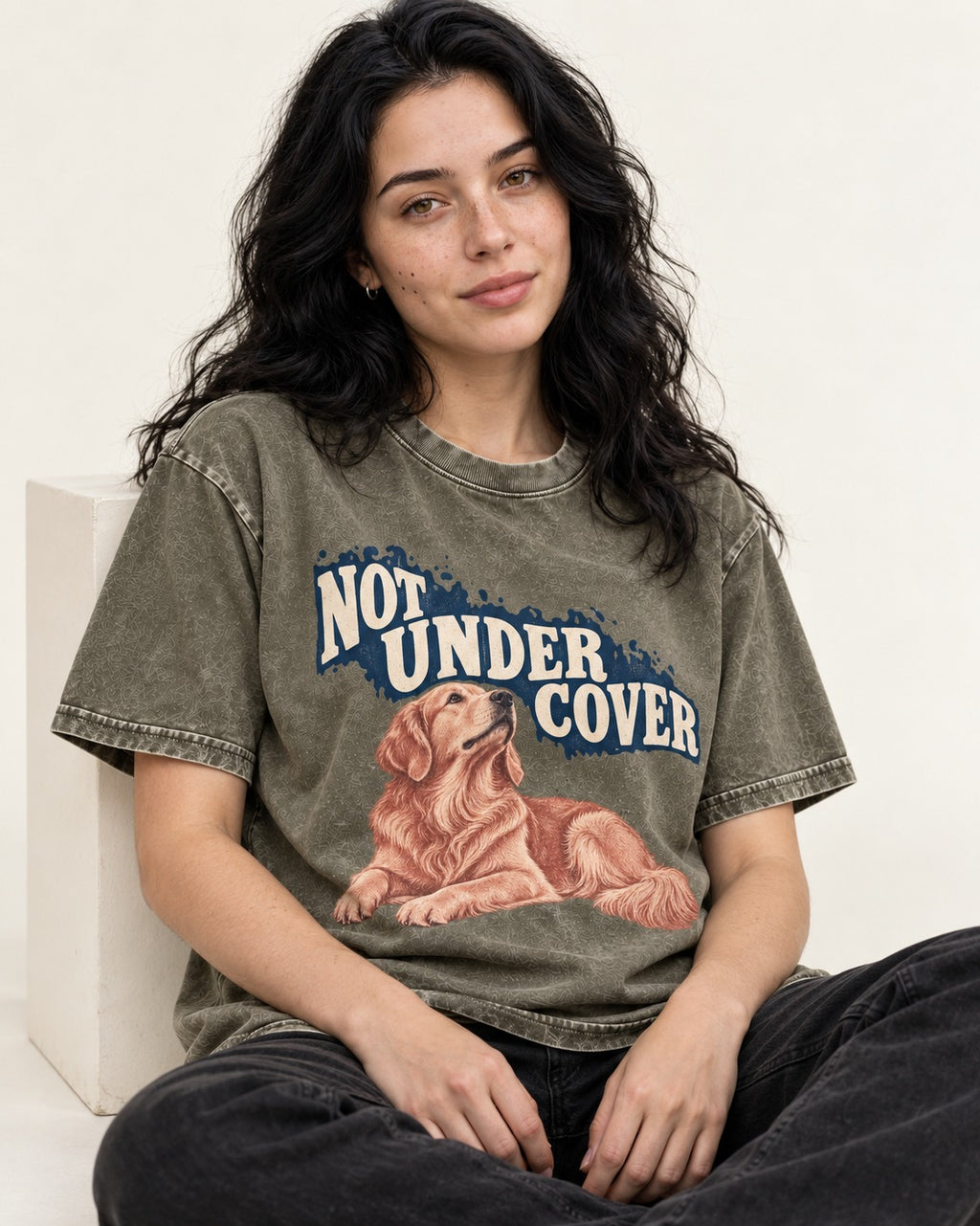 Not Under Cover Reclining Golden Retriever Graphic Washed Tee in Army Green, worn by a seated model