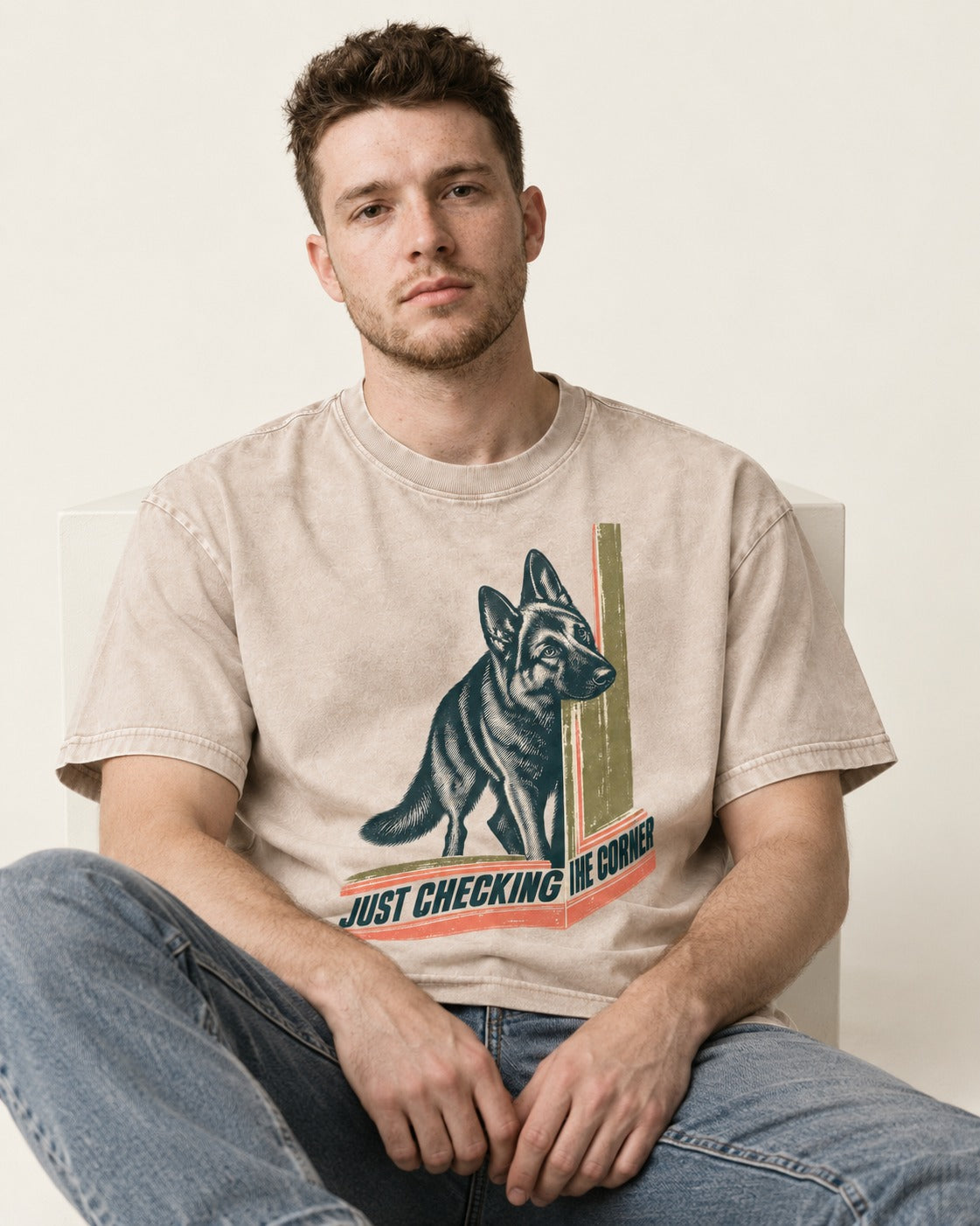 German Shepherd Dog Just Checking the Corner Washed Tee in Apricot, worn by a seated model