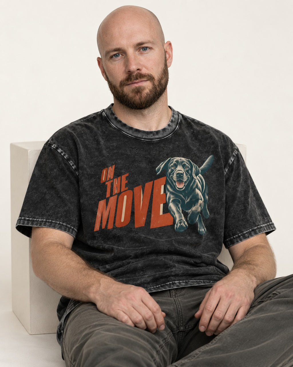 Labrador Retriever On the Move Running Graphic Washed Tee in Black, worn by a seated model
