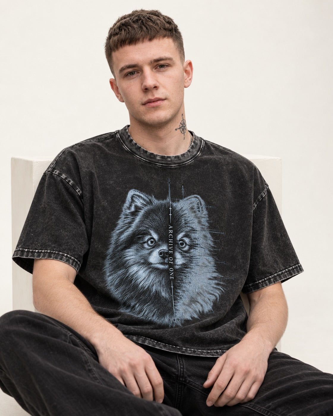 Pomeranian Archive of One Split Portrait Graphic Washed Tee in Black, worn by a seated model
