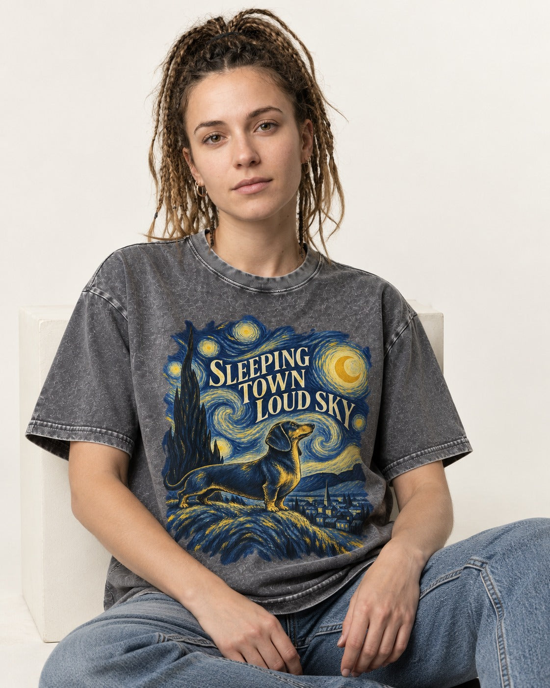 Dachshund Sleeping Town Loud Sky Starry Night Graphic Washed Tee in Gray, worn by a seated model