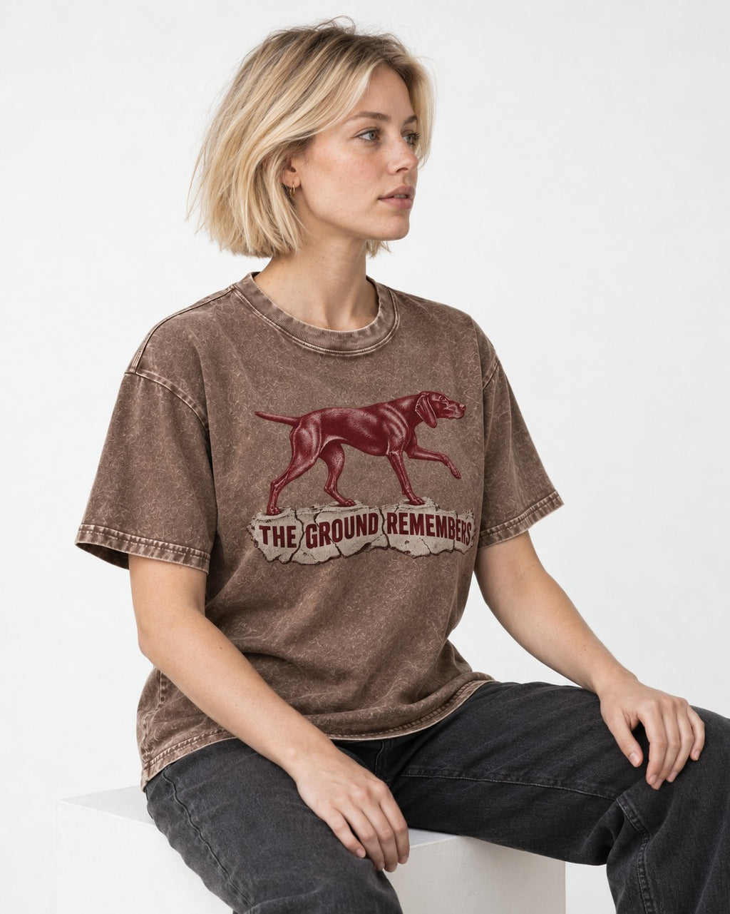 The Ground Remembers German Shorthaired Pointer Washed Tee in Coffee, worn by a seated model