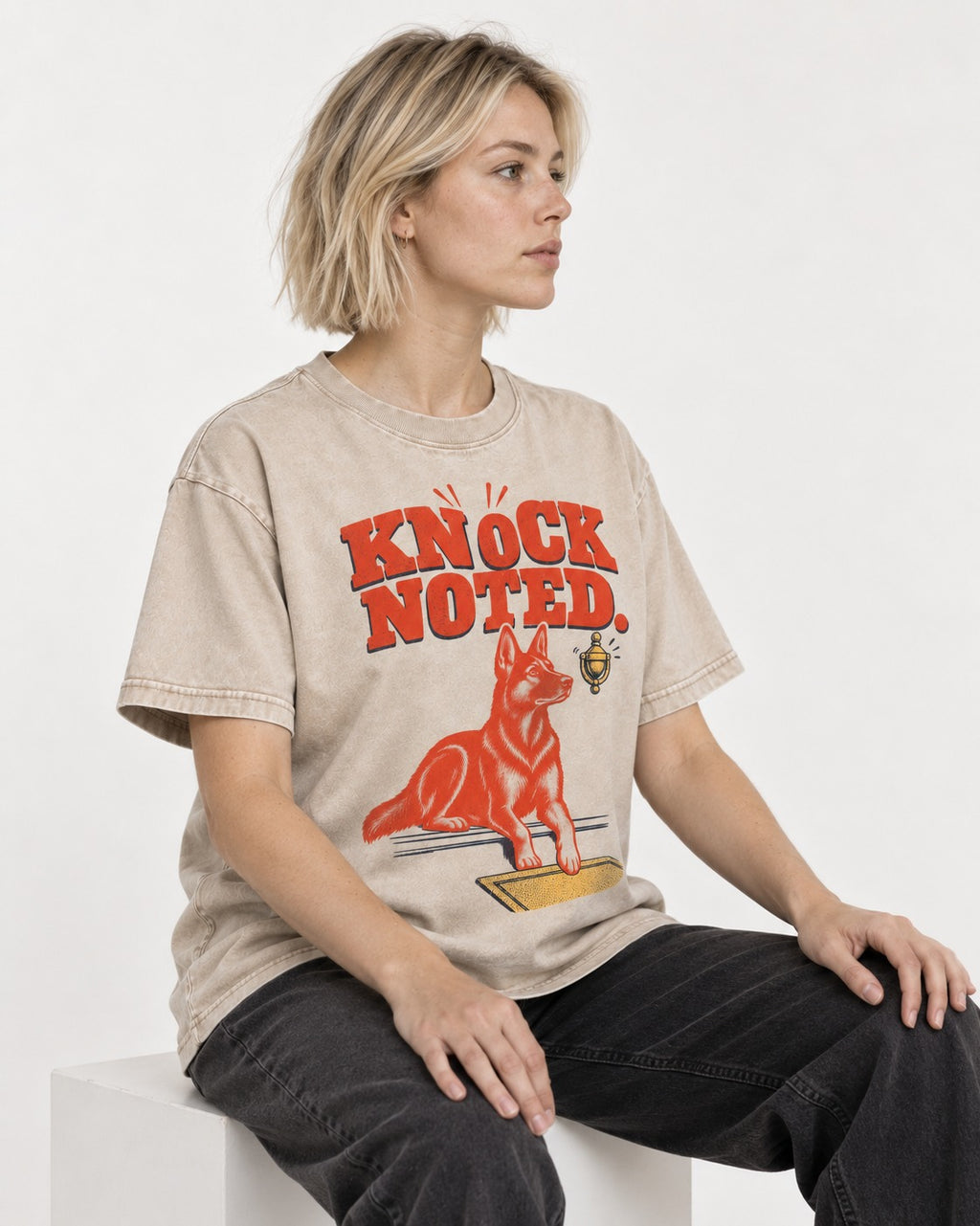 Knock Noted Door Knocker German Shepherd Dog Graphic Washed Tee in Apricot, worn by a seated model