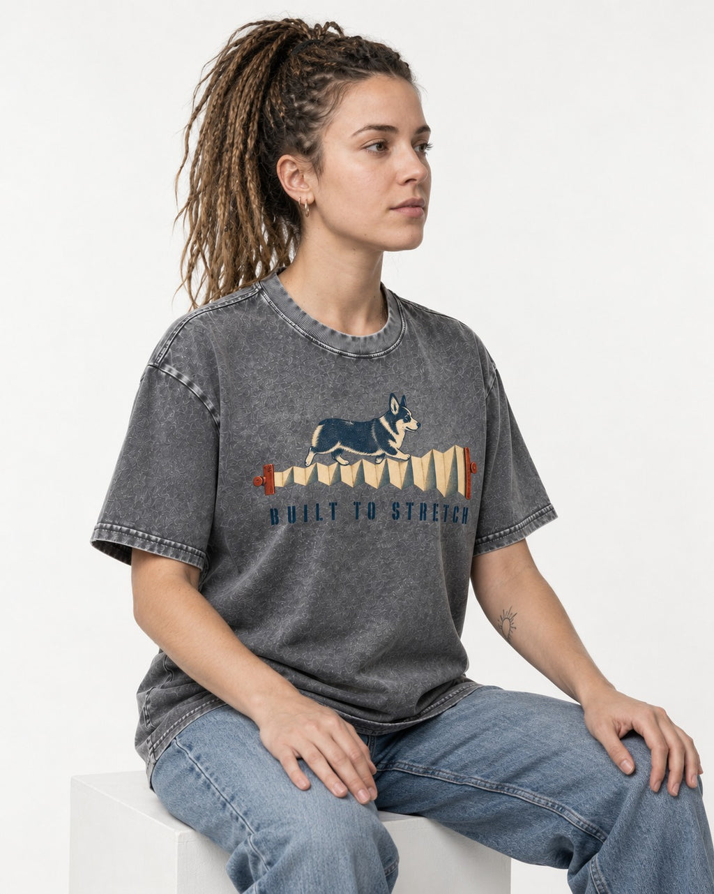 Corgi Built to Stretch Accordion Graphic Washed Tee in Gray, worn by a seated model