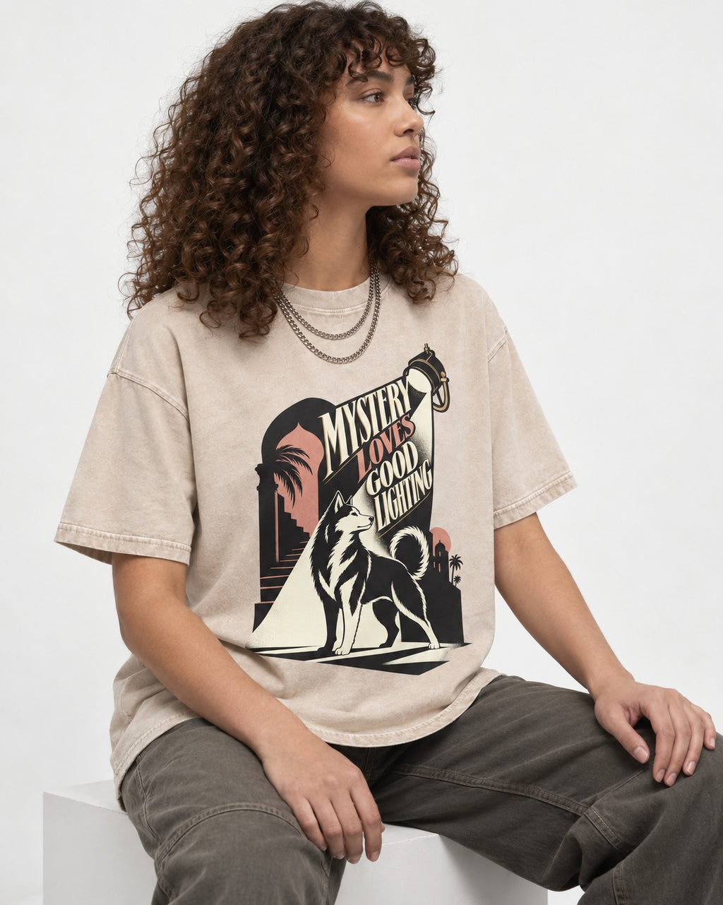 Husky Loves Good Lighting Washed Tee in Apricot, worn by a seated model