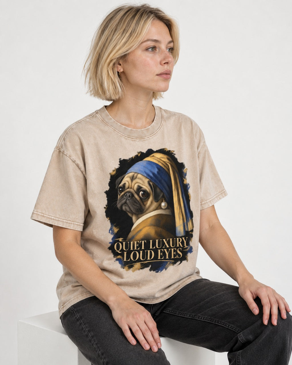 Pug Quiet Luxury Loud Eyes Pearl Portrait Graphic Washed Tee in Apricot, worn by a seated model