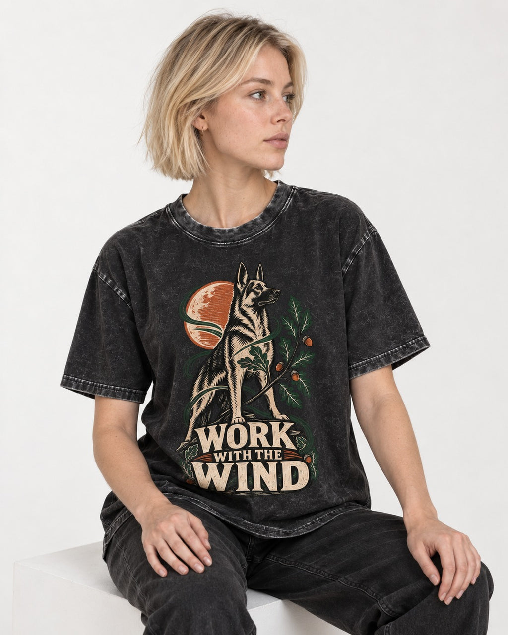 Work With The Wind Botanical Woodcut German Shepherd Dog Graphic Washed Tee in Black, worn by a seated model