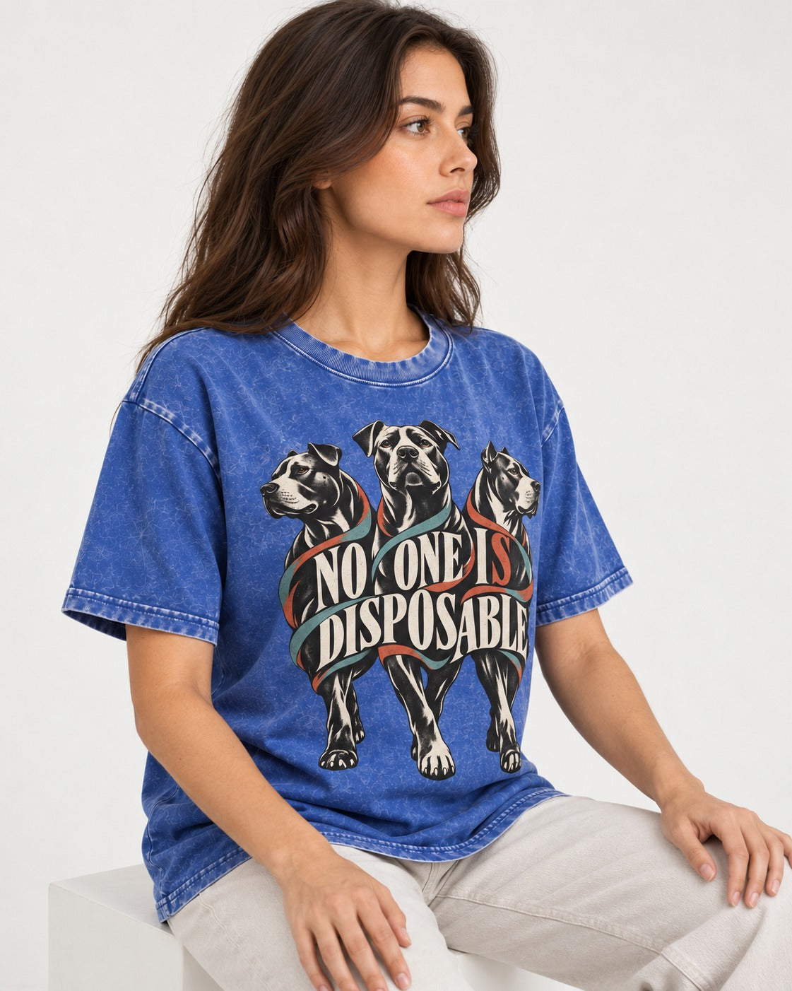 Pitbull No One Is Disposable Three Dogs Graphic Washed Tee in Royal Blue, worn by a seated model