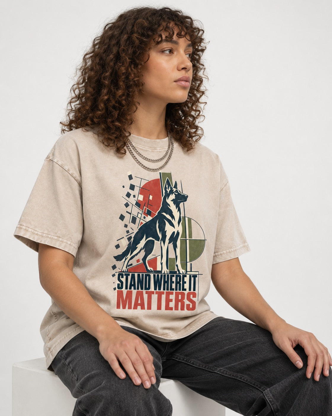 Stand Where It Matters German Shepherd Dog Washed Tee in Apricot, worn by a seated model