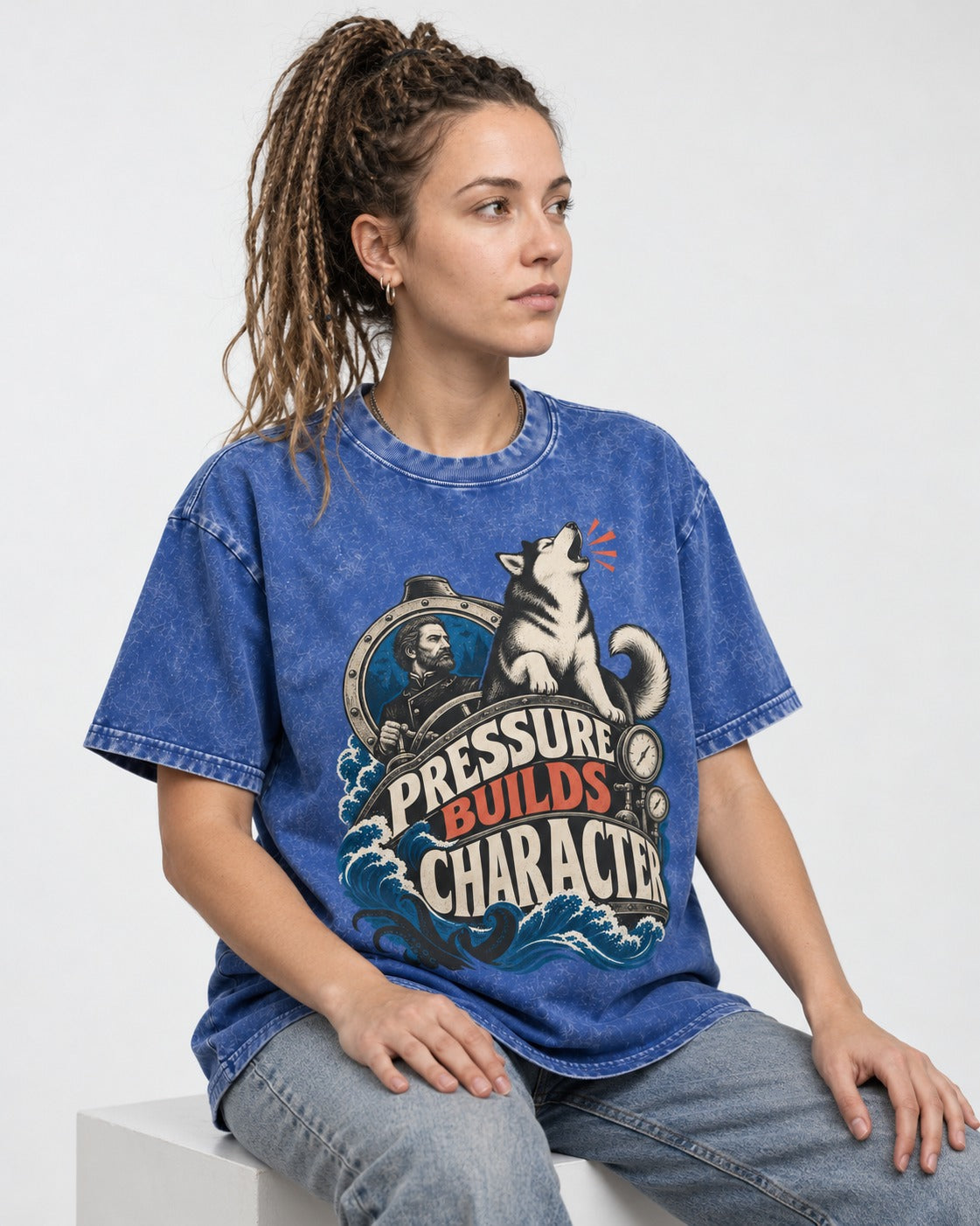 Husky Pressure Builds Character Deep Sea Graphic Washed Tee in Royal Blue, worn by a seated model