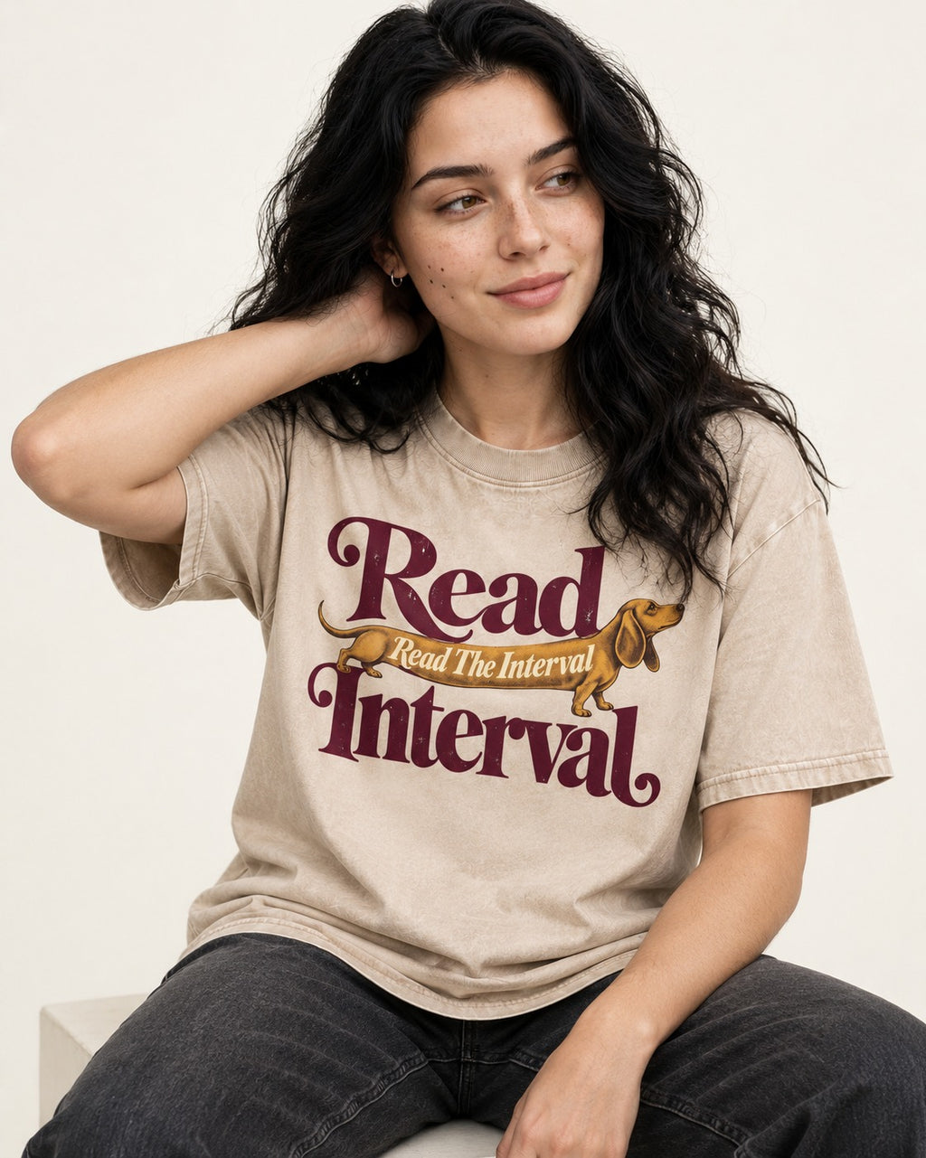 Read the Dachshund Interval Washed Tee in Apricot, worn by a seated model